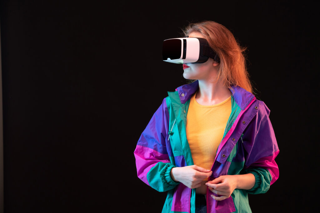 front view modern young lady colorful coat orange t shirt playing virtual reality black background gaming interactive play